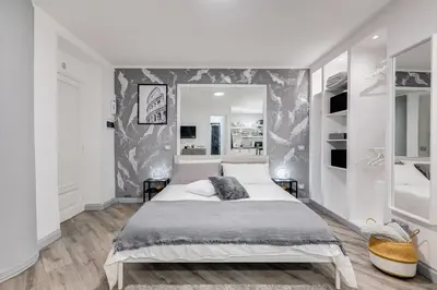 a bedroom with a large bed and a large mirror at Diecipassi dal Colosseo in Rome