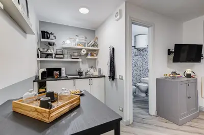 a kitchen with a table and a sink at Diecipassi dal Colosseo in Rome