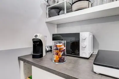 a kitchen counter with a blender with fruit in it at Diecipassi dal Colosseo in Rome