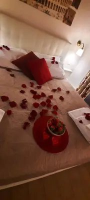 a bed with a bunch of red roses on it at Fabiola's Home in Rome