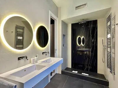 a bathroom with a sink and a toilet and mirrors at Private Luxury Suites in Rome