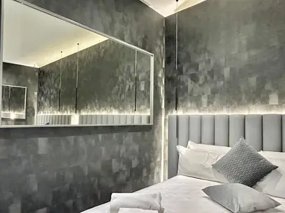 a bedroom with a large white bed with towels on it at Private Luxury Suites in Rome