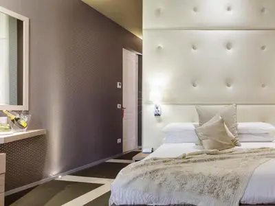 a bedroom with a mirror and a desk and a bed at Private Luxury Suites in Rome