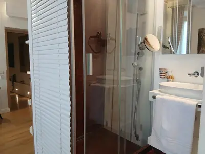 a bathroom with a glass shower and a sink at Excellent Trinity Rooms in Rome