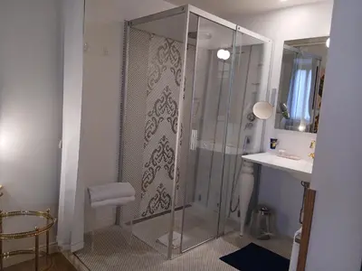 a bathroom with a glass shower and a sink at Excellent Trinity Rooms in Rome