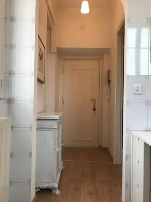 a hallway with a white door and a white counter at Attico incantevole, Pìgneto Roma in Rome