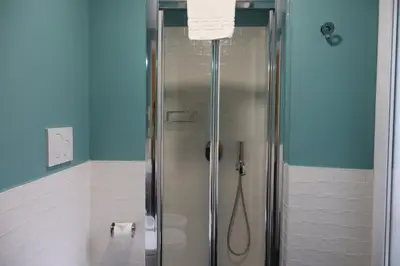 a shower with a glass door in a bathroom at Residenza Roma Imperiale in Rome
