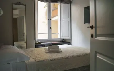 a bedroom with a bed with a towel on it at Residenza Roma Imperiale in Rome