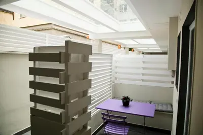 a room with a purple table and a pile of boxes at Colosseo Suite Apartment in Rome