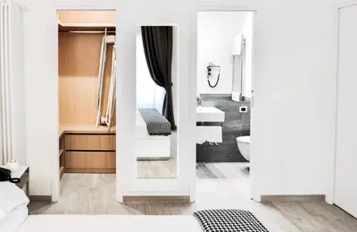 a white bathroom with a sink and a mirror at LHP Suite Roma Termini in Rome