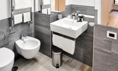 a bathroom with a white sink and a toilet at LHP Suite Roma Termini in Rome