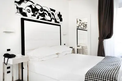 a white bedroom with a large mirror above a bed at LHP Suite Roma Termini in Rome