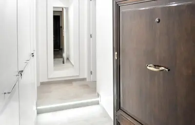 a hallway with a wooden door and a mirror at LHP Suite Roma Termini in Rome