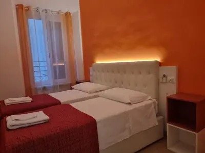 a bedroom with a white bed with a red blanket at Anthony House, Anthony Floor 3, Castro Pretorio in Rome