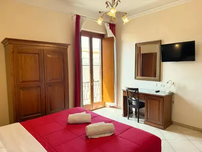 a bedroom with a red bed and a desk at Anthony House, Anthony Floor 3, Castro Pretorio in Rome
