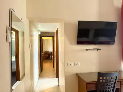 a living room with a television on the wall at Anthony House, Anthony Floor 3, Castro Pretorio in Rome