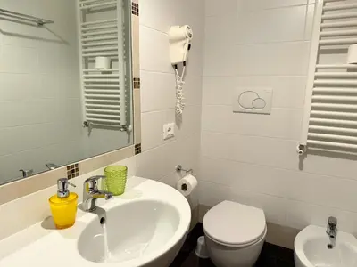 a bathroom with a sink and a toilet and a mirror at Anthony House, Anthony Floor 3, Castro Pretorio in Rome