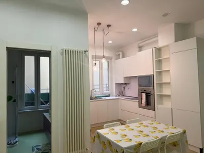 a kitchen with a table with a yellow table cloth on it at Anthony House, Anthony Floor 3, Castro Pretorio in Rome