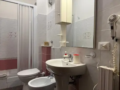 a bathroom with a sink and a toilet at Domi 56 Apartment in Rome