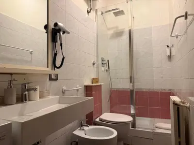 a bathroom with a toilet and a sink and a shower at Domi 56 Apartment in Rome