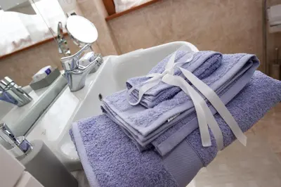 a bathroom with purple towels sitting on a sink at Residenza il Parco 3 in Rome