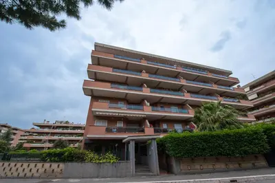 a tall apartment building with bushes in front of it at Residenza il Parco 3 in Rome