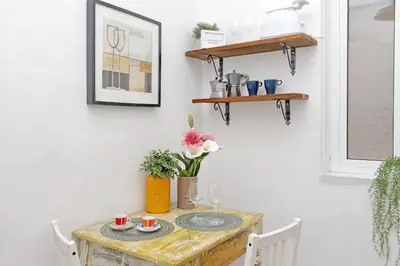a table with plates and cups on it in a room at Tevere apartments in Rome