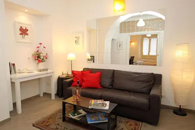 a living room with a brown couch and a table at Great Central Apartment in Rome