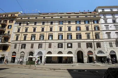 a large building on a street with people walking in front of it at Great Central Apartment in Rome