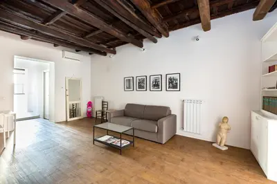 a living room with a couch and a table at Vicoloft Vicolo in Rome