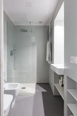a white bathroom with a shower and a sink at Vicoloft Vicolo in Rome