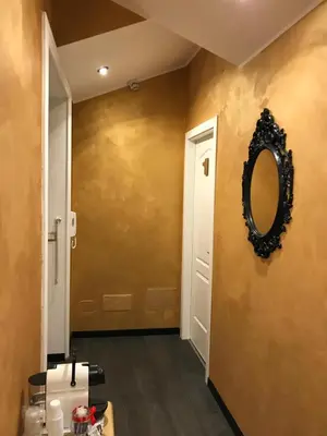 a hallway with a mirror on a wall at Secret Rhome in Rome