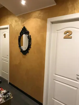 a hallway with a door and a mirror on a wall at Secret Rhome in Rome