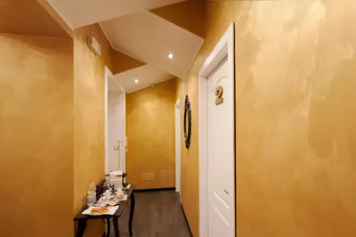 a hallway with a table and a white door at Secret Rhome in Rome