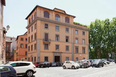 a building with cars parked in a parking lot at Secret Rhome in Rome