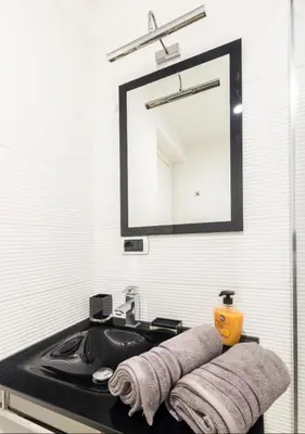 a bathroom with a black sink and a mirror at Terrace with Tiber View - Trastevere in Rome