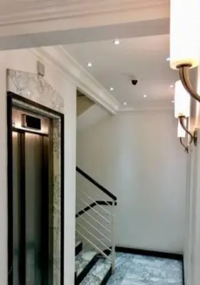 a hallway with a staircase in a building at Terrace with Tiber View - Trastevere in Rome