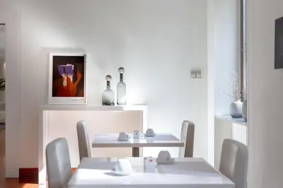 a dining room with two tables and two chairs at Phi Hotel Garden Area Roma Eur in Rome