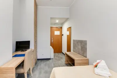 a hotel room with two beds and a desk at Phi Hotel Garden Area Roma Eur in Rome