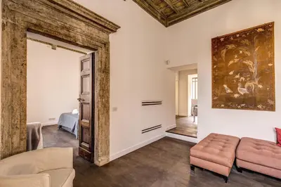 a living room with a couch and a painting on the wall at Piazza Farnese exclusive view 2 bedroom en suite in Rome