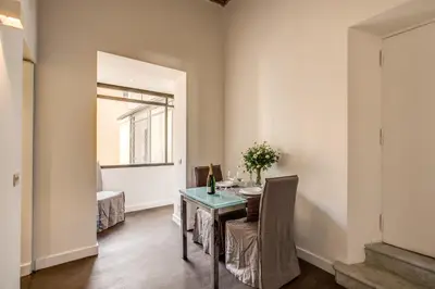 a dining room with a table and a window at Piazza Farnese exclusive view 2 bedroom en suite in Rome