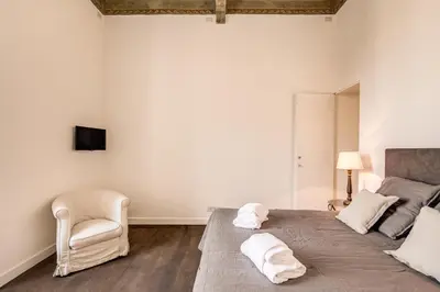 a bedroom with a bed with two towels on it at Piazza Farnese exclusive view 2 bedroom en suite in Rome