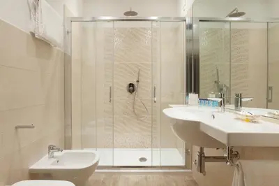 a bathroom with a shower and a sink and a toilet at Jackie's Apartments in Rome