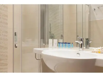 a bathroom with a sink and a shower at Jackie's Apartments in Rome