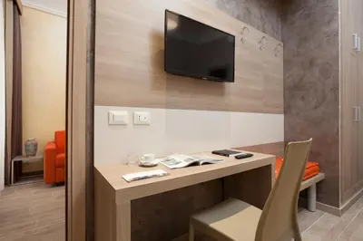 a room with a desk with a tv on a wall at Jackie's Apartments in Rome