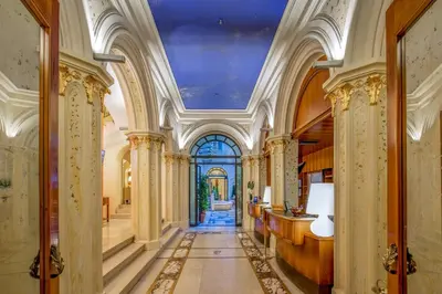 a hallway in a building with a ceiling at UNA Hotels Empire Roma in Rome