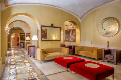 a lobby with couches and tables in a building at UNA Hotels Empire Roma in Rome
