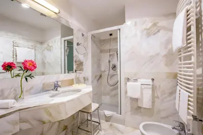 a bathroom with a sink and a shower at UNA Hotels Empire Roma in Rome