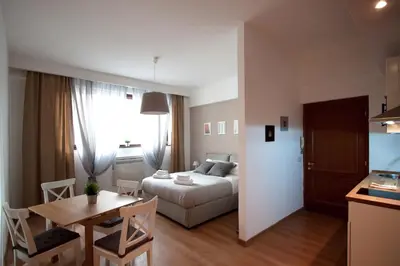 a small apartment with a bed and a table and a kitchen at Albornoz 35 in Rome