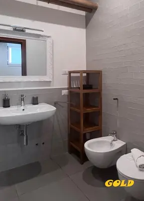 a bathroom with a sink and a toilet and a mirror at Albornoz 35 in Rome